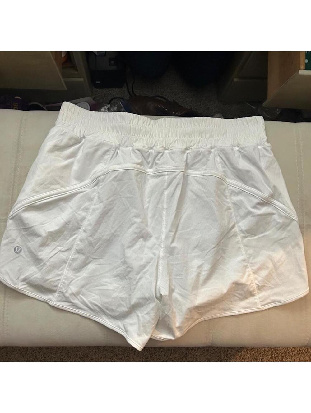 White Lululemon athletic high-rise shorts wide waistband and zip pockets size 10